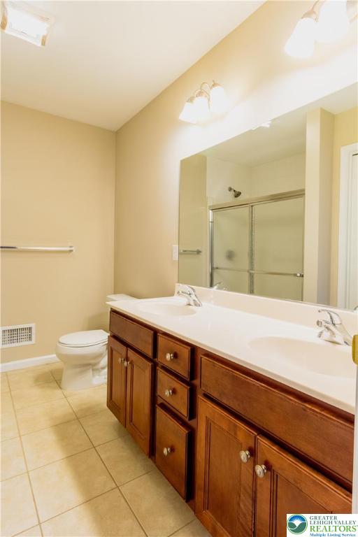 4138 Walter Road Bethlehem, PA 18020 - Photo 23 of 39 a spacious bathroom with a double vanity sink toilet and a mirror