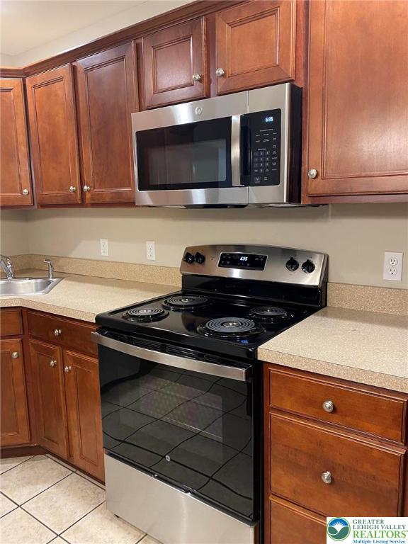 4138 Walter Road Bethlehem, PA 18020 - Photo 9 of 39 a kitchen with stainless steel appliances granite countertop a stove and a microwave