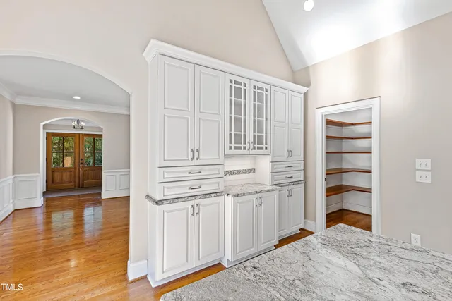 a view of a hallway with wooden floor and entryway