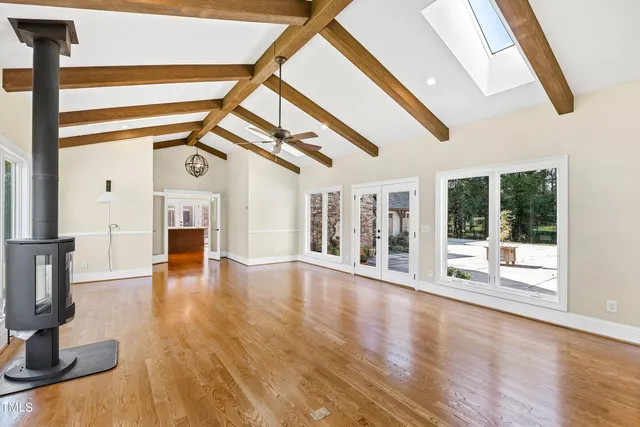 a view of a room with wooden floor and windows