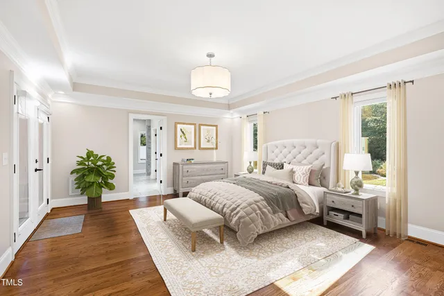 a bedroom with a bed and a wooden floor