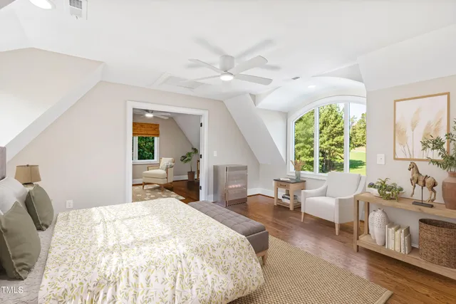 a view of a lake with a big yard and large trees