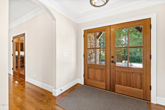 a view of a livingroom with wooden floor a fireplace and windows