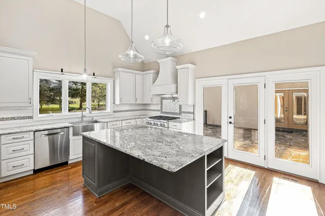 a living room with furniture a fireplace and a large window