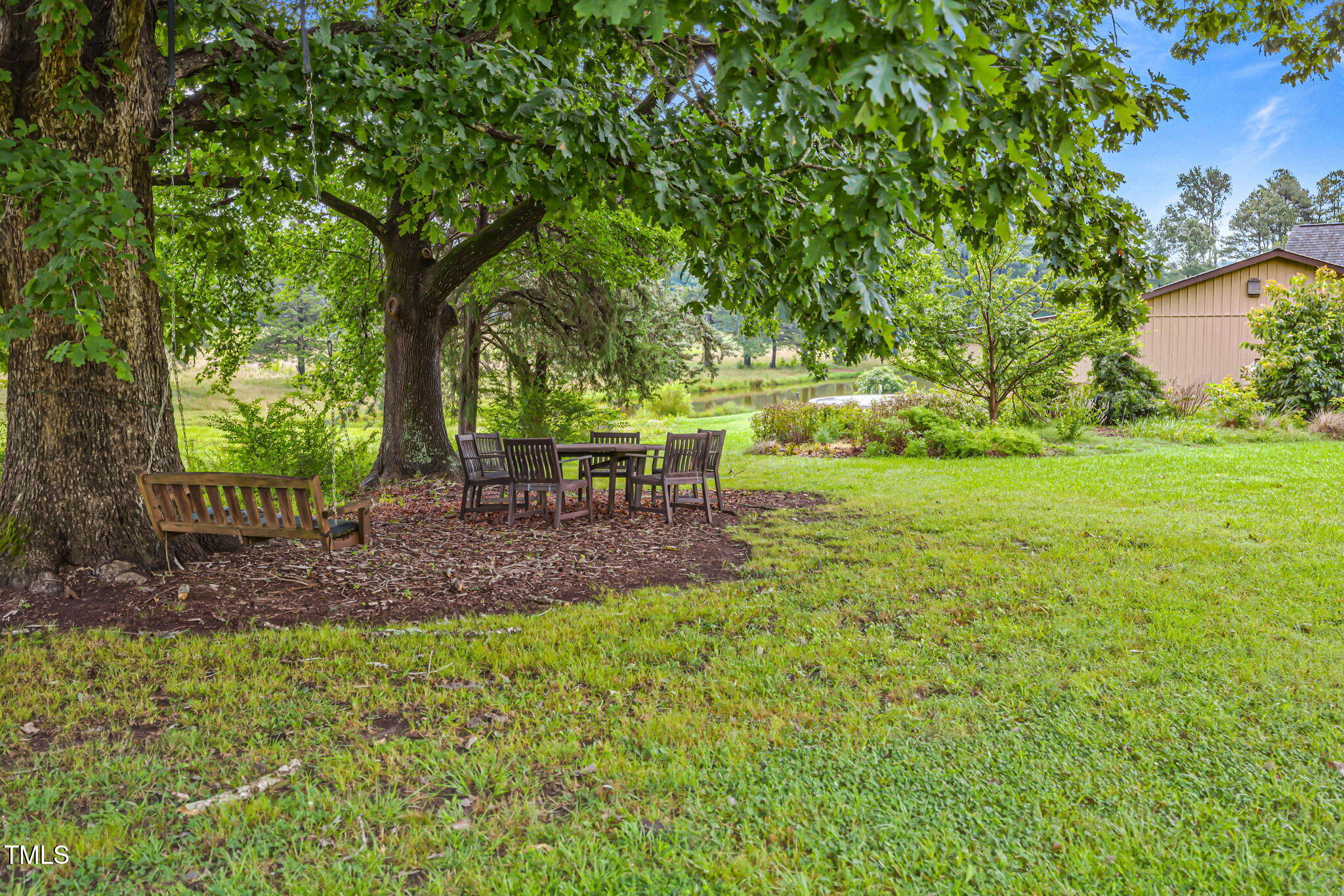 3700 Lark Farm Road Franklinton, NC 27525 - Photo 85 of 87 a view of a backyard with table and chairs a barbeque and a large trees