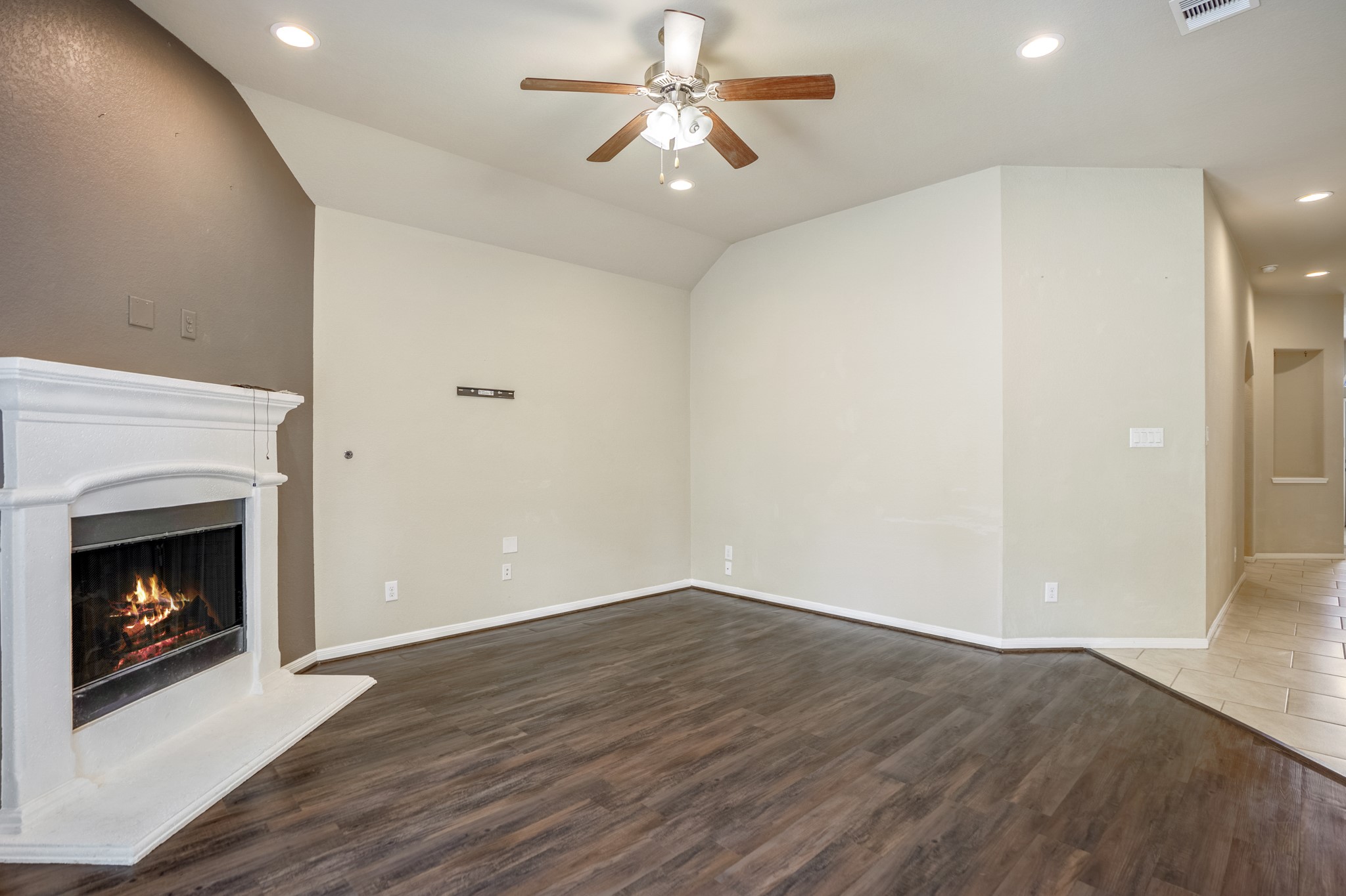 5319 Claymore Meadow Lane Spring, TX 77389 - Photo 11 of 34 a view of a livingroom with a fireplace a ceiling fan and wooden floor