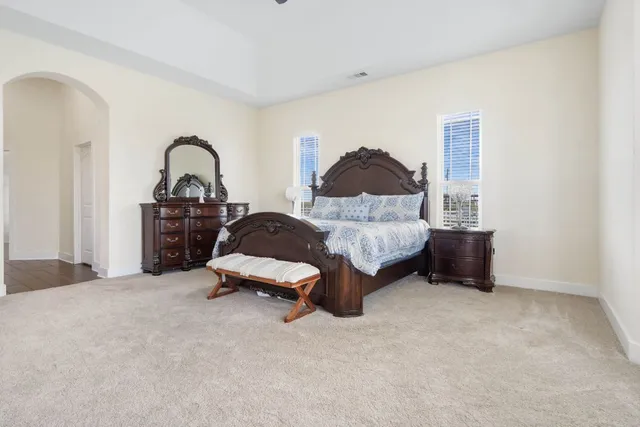 a bedroom with a bed and a chandelier