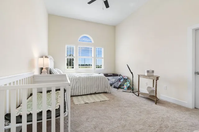 a bedroom with a bed a couch and a window