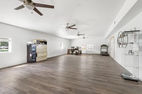 a view of a livingroom with hardwood floor and a ceiling fan