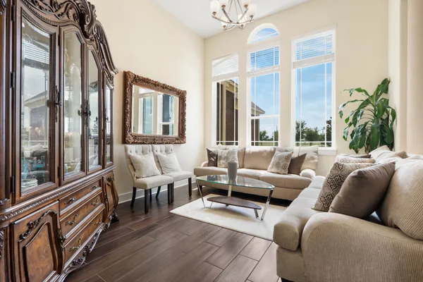 a living room with furniture fireplace and a large window