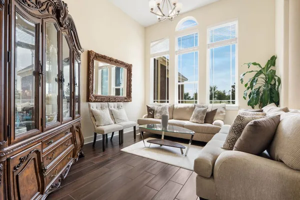 a living room with furniture fireplace and a large window