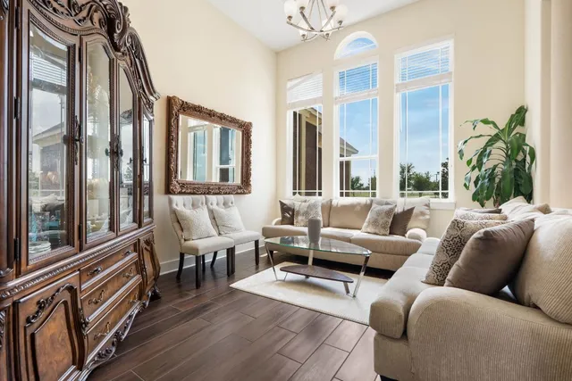 a living room with furniture fireplace and a large window