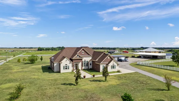 an aerial view of a house with a yard basket ball court and outdoor seating