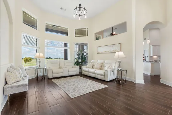 a living room with furniture and a wooden floor