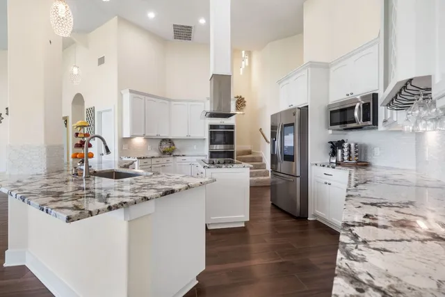 a kitchen with a refrigerator and a sink