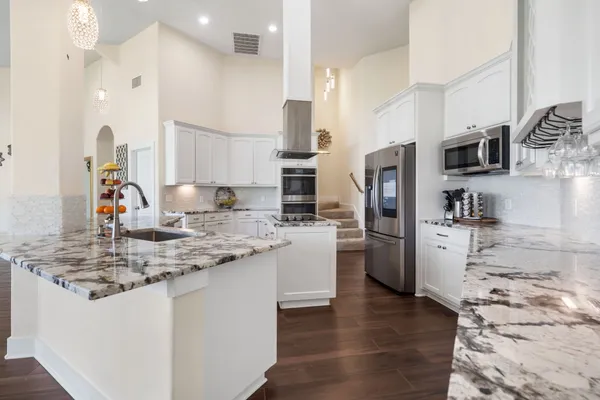 a kitchen with a refrigerator sink and stove
