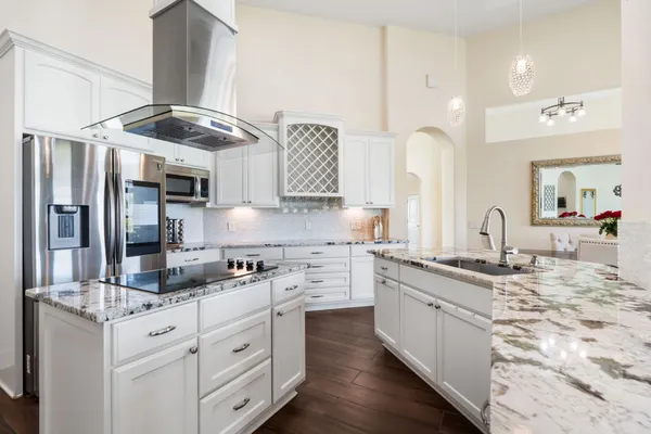 a kitchen with stainless steel appliances granite countertop a sink stove and refrigerator