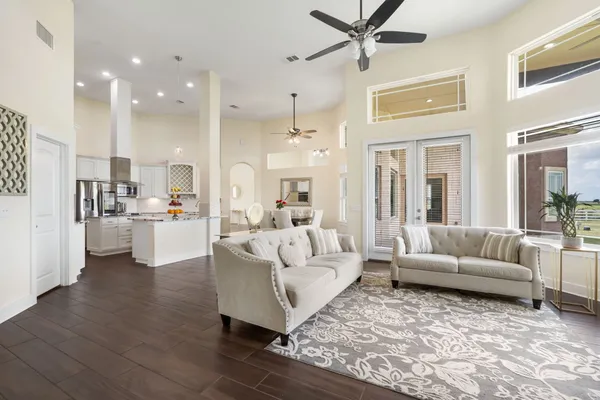 a living room with furniture and kitchen view