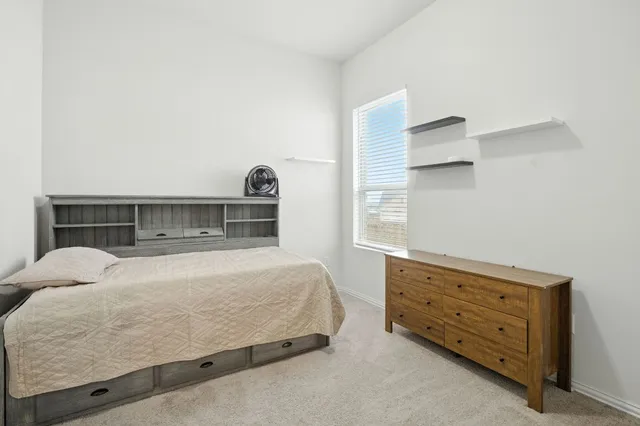 a bedroom with a bed and window