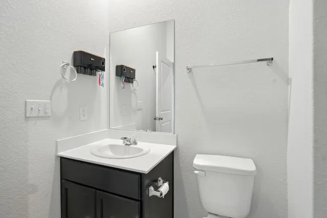a bathroom with a toilet a sink and shower