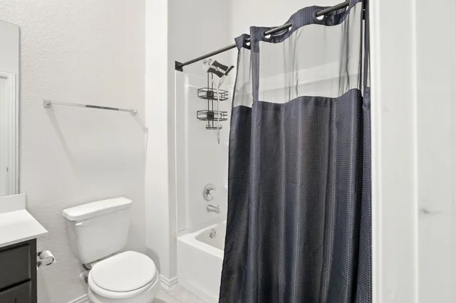 a bedroom with bed and a chandelier