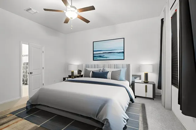 a bedroom with a large bed and a chandelier