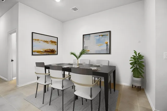 an empty room with painting on the wall