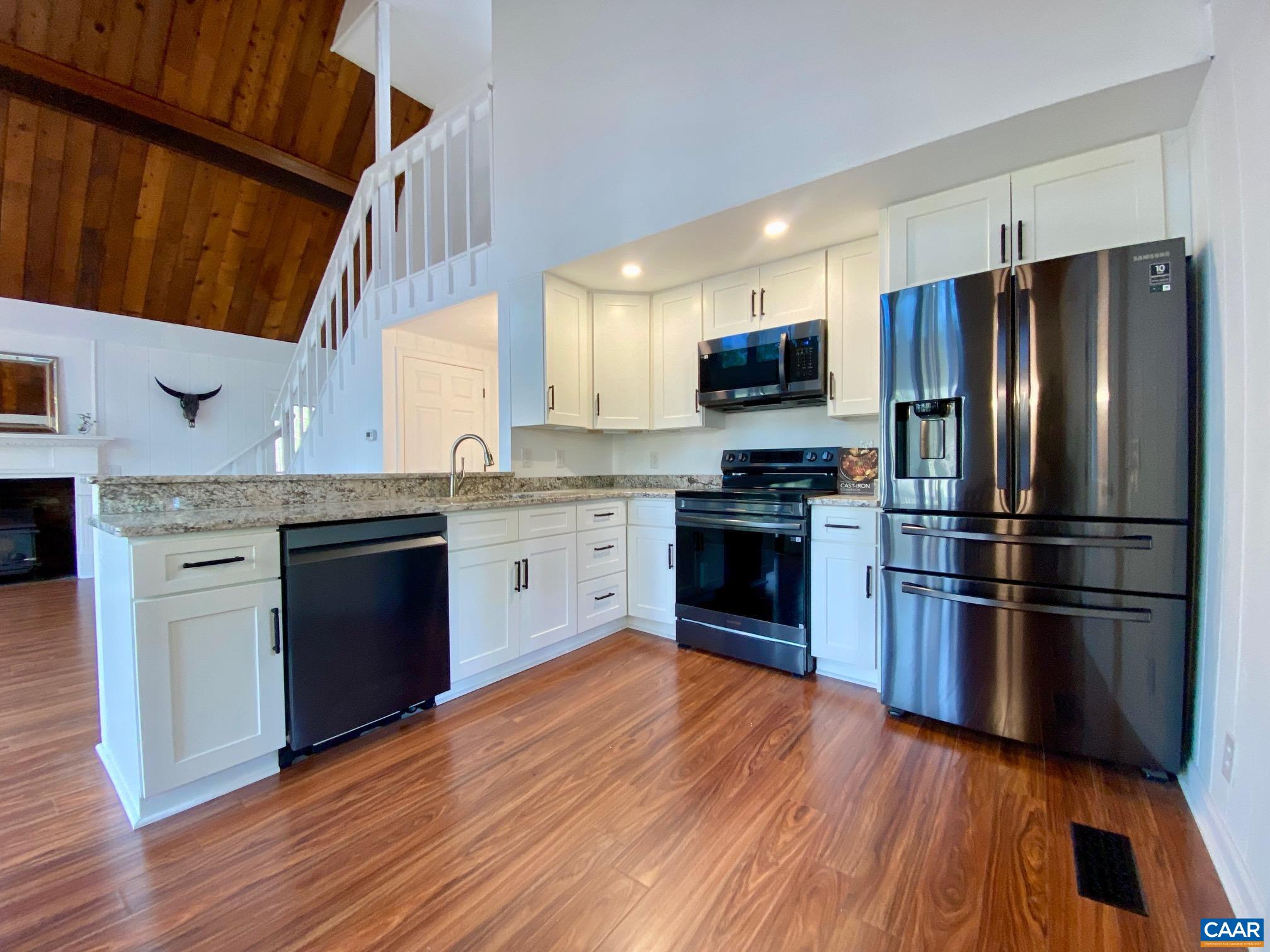 24 Tanglewood Road Palmyra, VA 22963 - Photo 9 of 23 a kitchen with wooden floors stainless steel appliances and sink