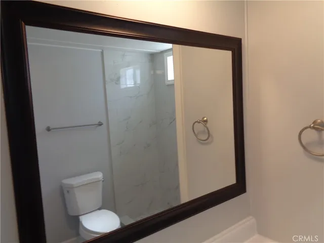 a bathroom with a toilet and a shower