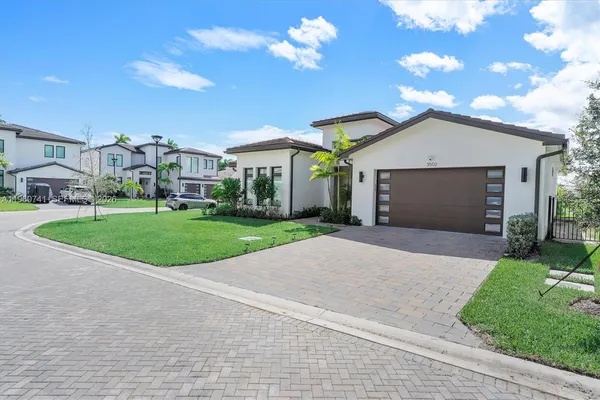 a view of a house with a yard and garage