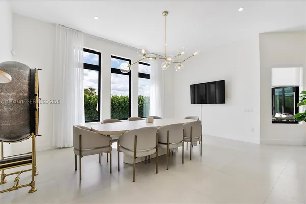 a view of a dining room with furniture window and wooden floor