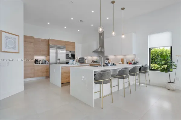 a kitchen that has a lot of cabinets in it and appliances