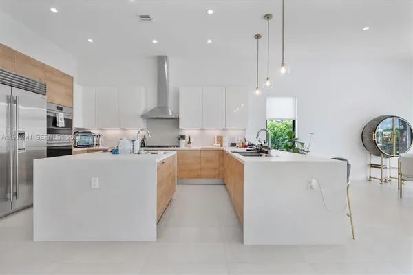 a kitchen with granite countertop a stove and white cabinets