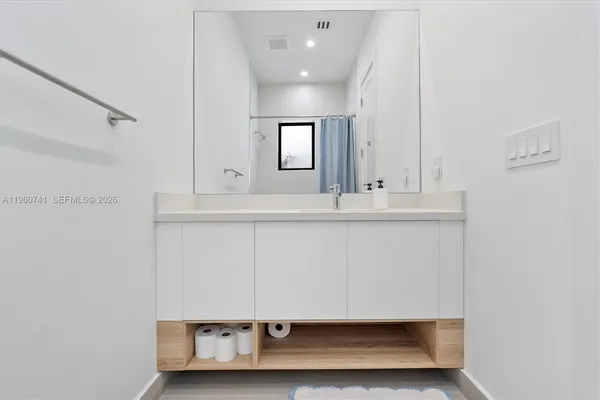 a white toilet sitting next to a bath tub