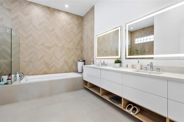 a spacious bathroom with a bathtub and shower