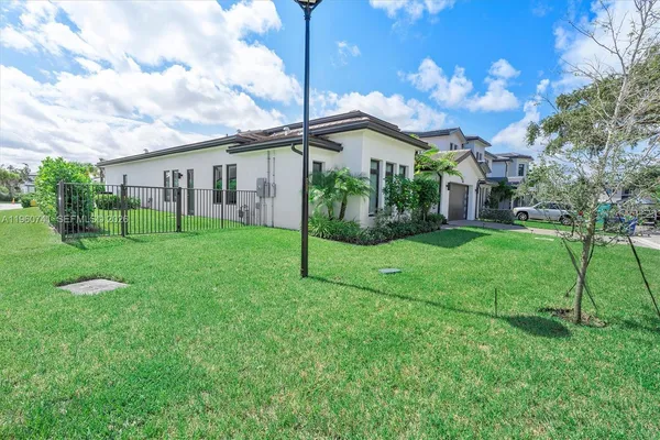 a view of a patio with couches table and chairs and potted plants