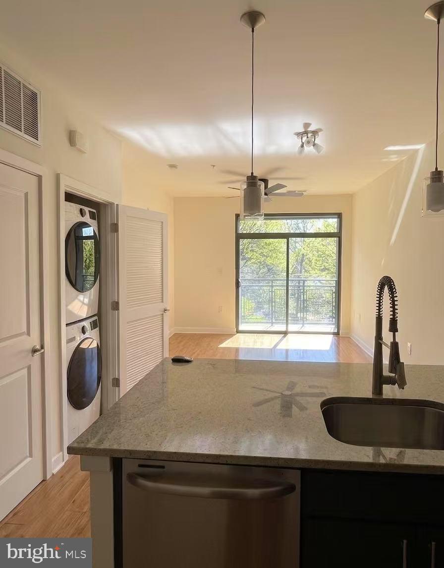 8005 13th Street, Unit 310 Silver Spring, MD 20910 - Photo 8 of 11 a kitchen with a sink a stove and a wooden floor