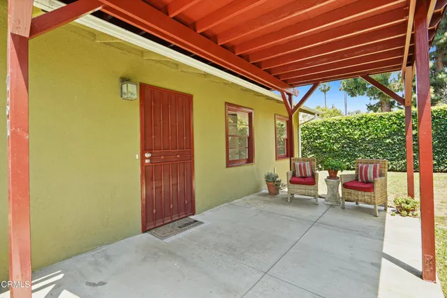 a view of a house with a yard and sitting area