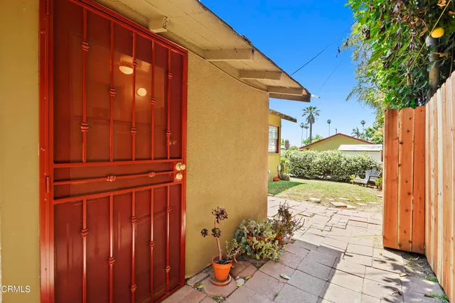 a view of a livingroom with wooden floor and a ceiling fan