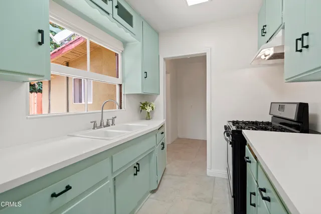 a kitchen with a stove and a sink