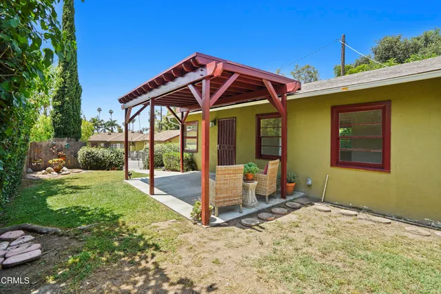 a view of a house with backyard porch and sitting area