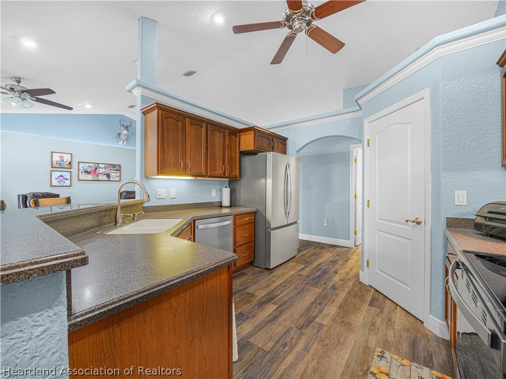 5430 Lakewood Road Sebring, FL 33875 - Photo 11 of 40 a kitchen with stainless steel appliances granite countertop a refrigerator a sink and a stove