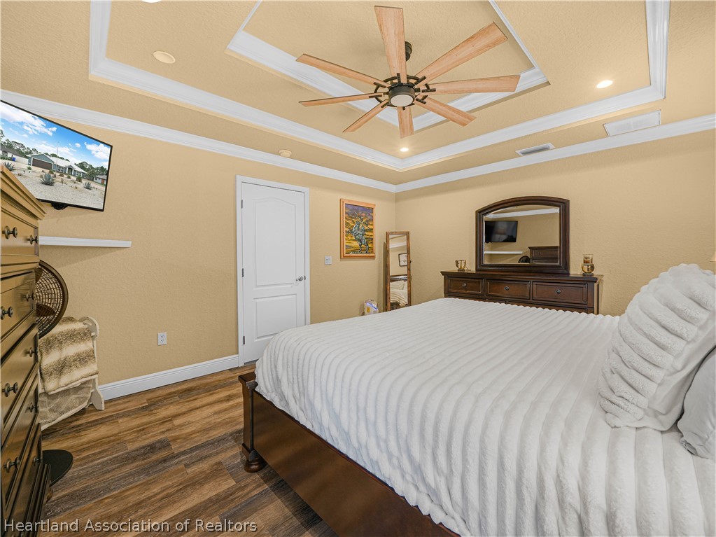 5430 Lakewood Road Sebring, FL 33875 - Photo 14 of 40 a bedroom with a bed and a chandelier