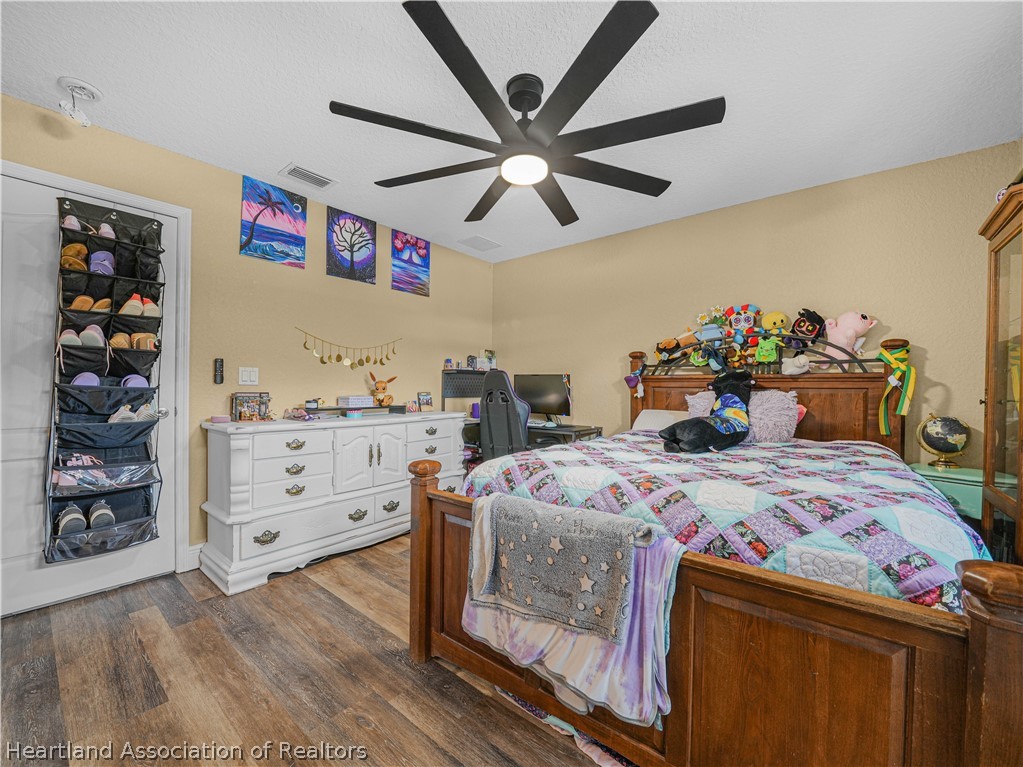 5430 Lakewood Road Sebring, FL 33875 - Photo 18 of 40 a bedroom with a bed and a walk in closet