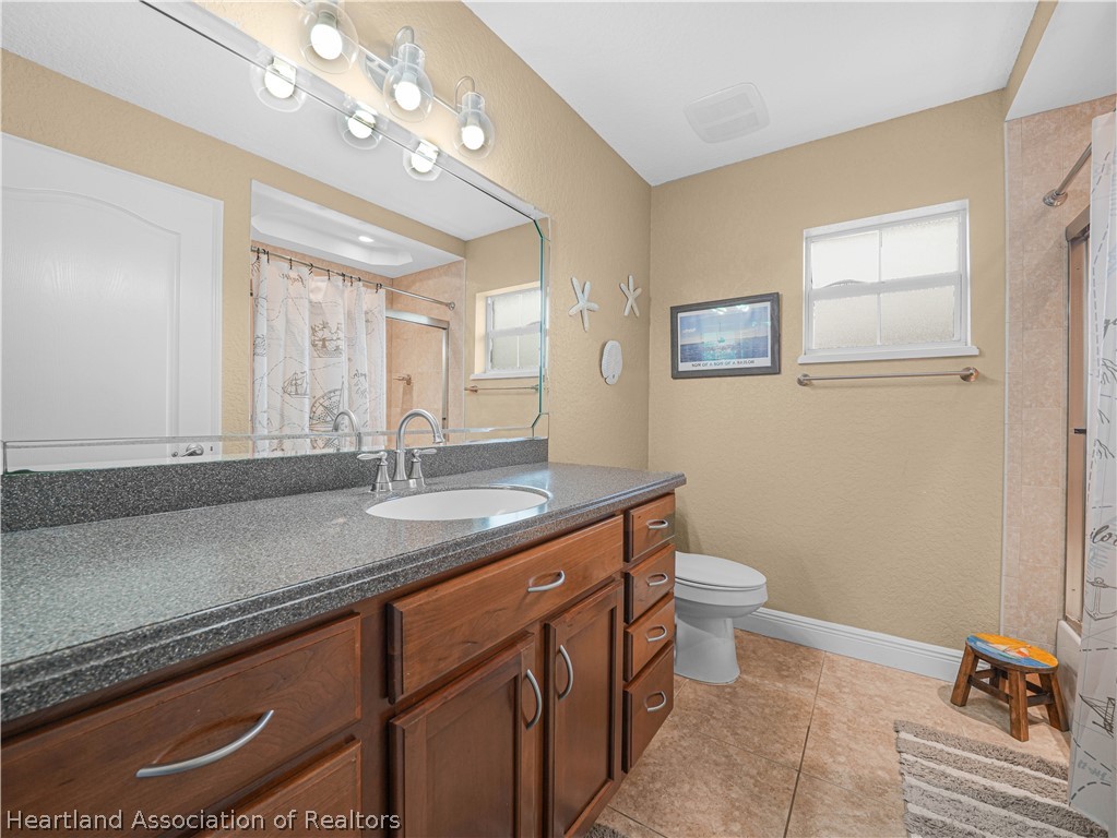 5430 Lakewood Road Sebring, FL 33875 - Photo 19 of 40 a bathroom with a double vanity sink and a toilet