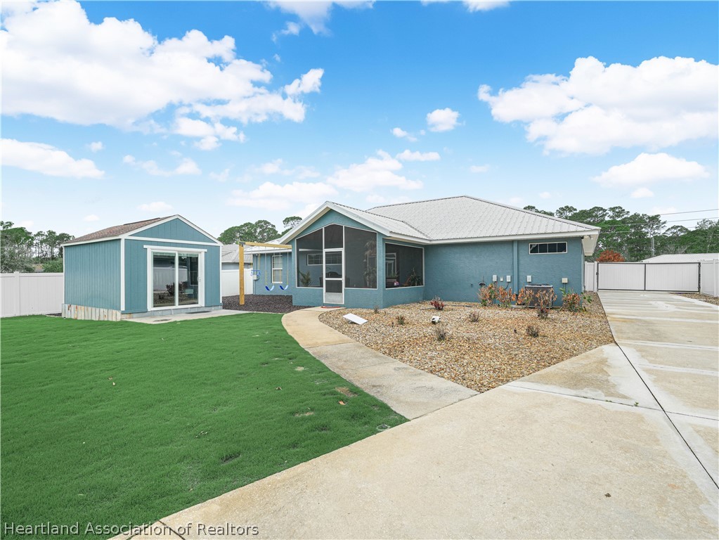 5430 Lakewood Road Sebring, FL 33875 - Photo 26 of 40 a view of a house with a backyard