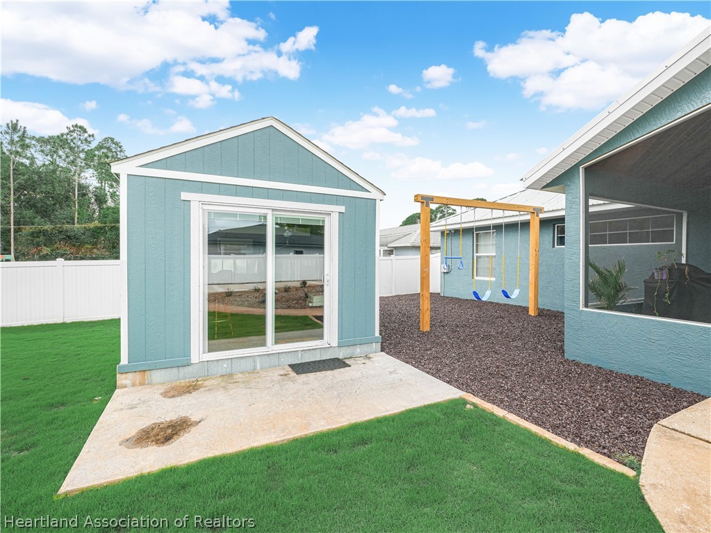 5430 Lakewood Road Sebring, FL 33875 - Photo 29 of 40 a front view of a house with a yard