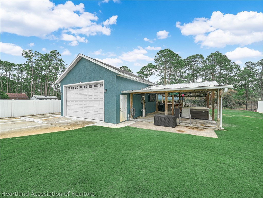 5430 Lakewood Road Sebring, FL 33875 - Photo 32 of 40 a view of a house with a yard and sitting area