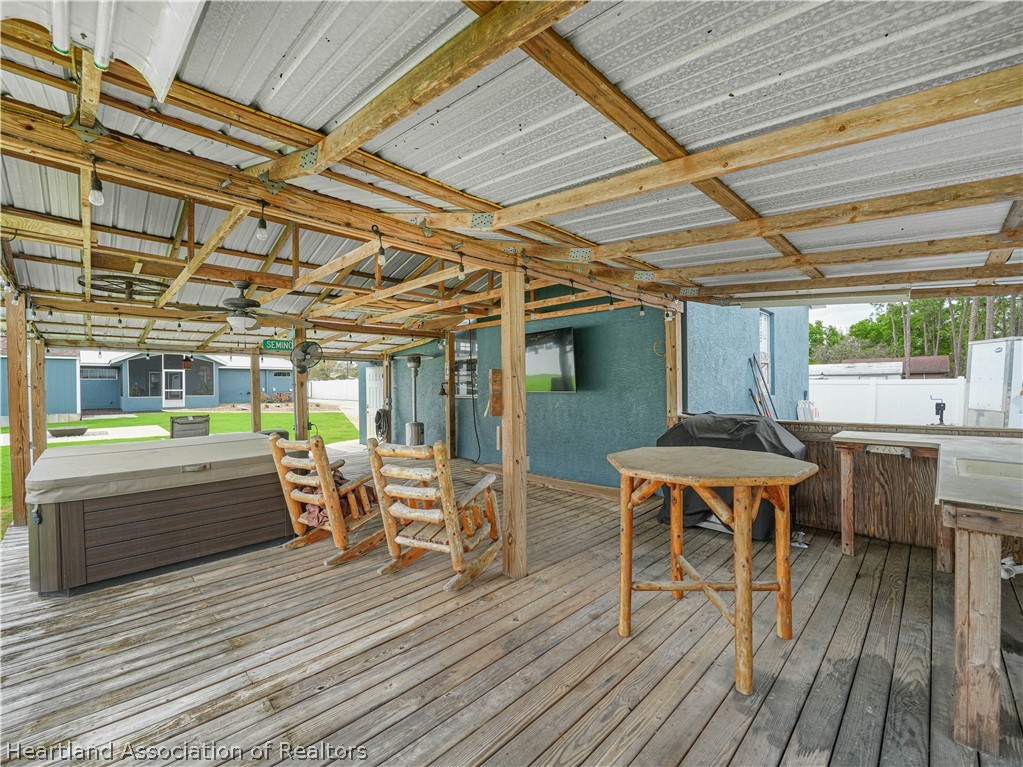 5430 Lakewood Road Sebring, FL 33875 - Photo 34 of 40 a dining room with wooden floor and outdoor space
