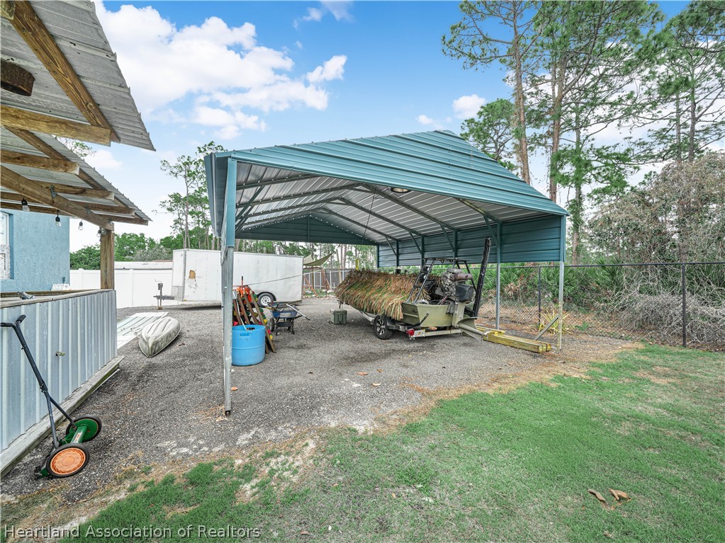 5430 Lakewood Road Sebring, FL 33875 - Photo 35 of 40 a view of backyard with wooden fence and a table